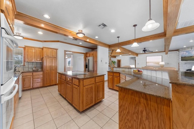 kitchen featuring hanging light fixtures, black electric cooktop, tasteful backsplash, a kitchen island, and stainless steel fridge with ice dispenser