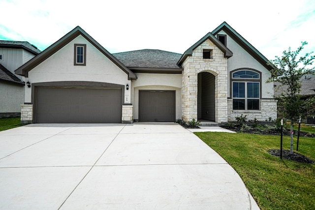 french country inspired facade with a garage and a front yard