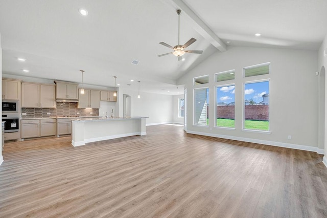 unfurnished living room with beamed ceiling, high vaulted ceiling, light wood-style floors, baseboards, and ceiling fan