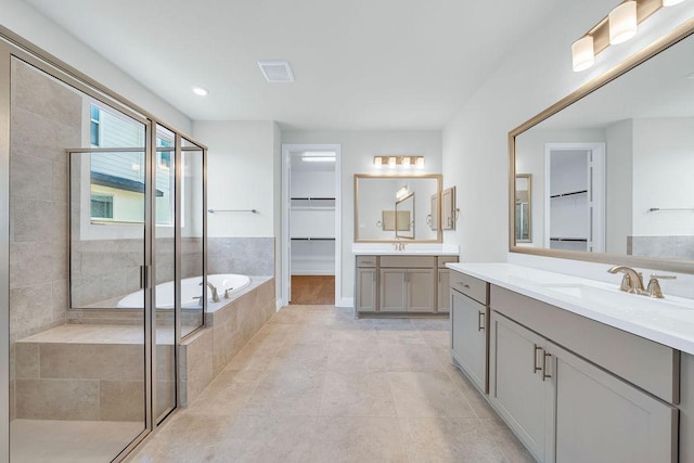 413 Canton Chase, Cibolo, TX 78108 - full bathroom with a walk in closet, a shower stall, two vanities, a bath, and tile patterned flooring