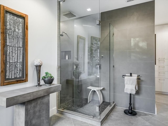 bathroom featuring tile patterned flooring and a shower with door