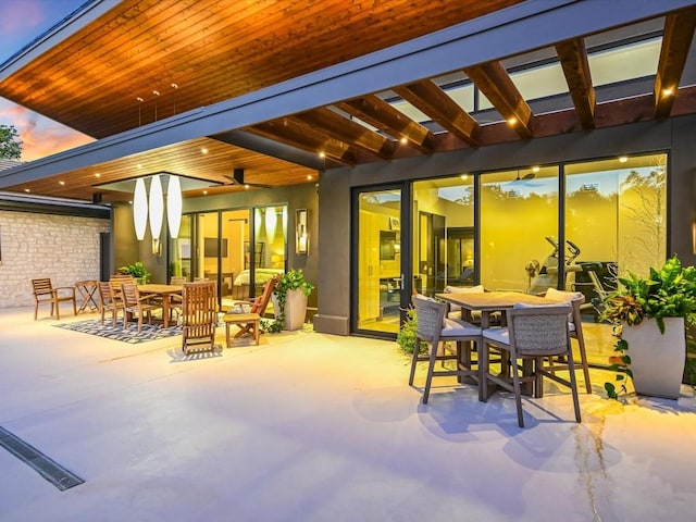 patio terrace at dusk featuring ceiling fan