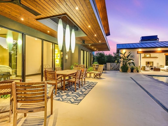 patio terrace at dusk with ceiling fan and a pool