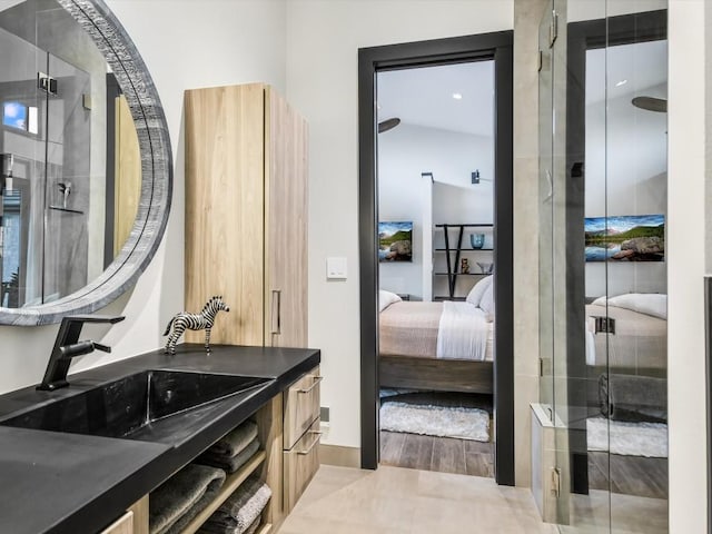 bathroom featuring wood-type flooring, vanity, and a shower with door