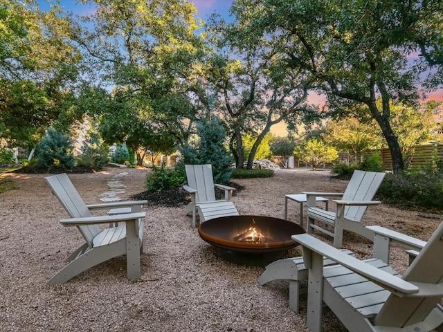 patio terrace at dusk featuring an outdoor fire pit