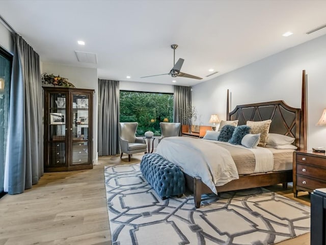 bedroom with ceiling fan and light wood-type flooring