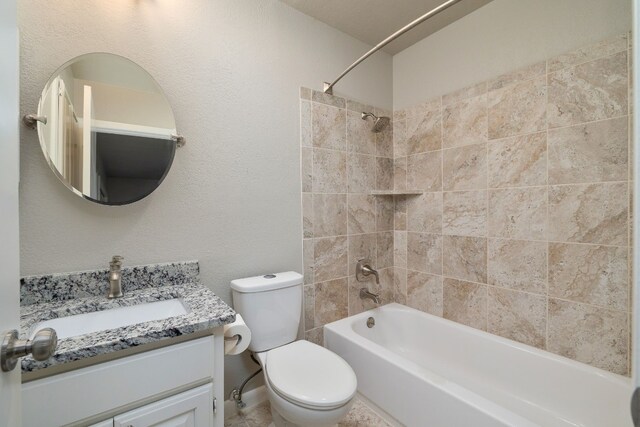 full bathroom featuring vanity, toilet, and tiled shower / bath combo