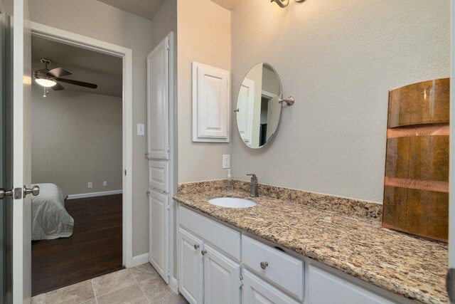 bathroom with ceiling fan, hardwood / wood-style floors, and vanity