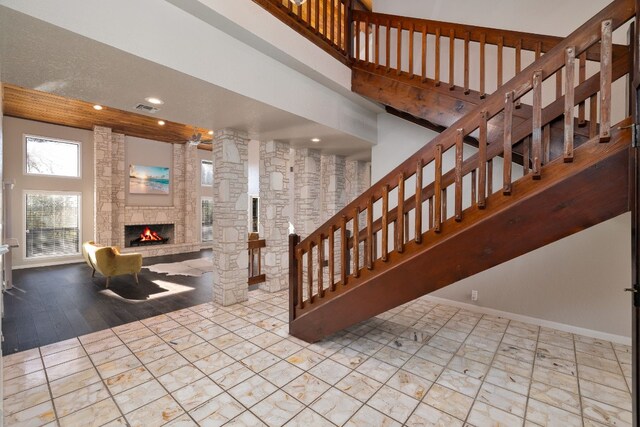 stairs with hardwood / wood-style flooring and a fireplace