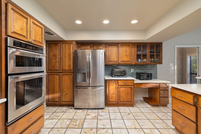 kitchen with decorative backsplash and appliances with stainless steel finishes