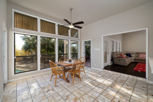 dining area with ceiling fan and vaulted ceiling