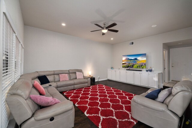 living room with dark hardwood / wood-style floors and ceiling fan