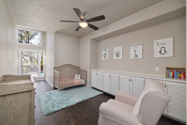 bedroom with access to outside, a textured ceiling, dark hardwood / wood-style floors, and ceiling fan