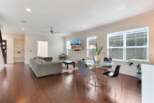 dining space featuring dark hardwood / wood-style flooring and ornamental molding