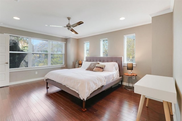 bedroom featuring dark hardwood / wood-style flooring, ceiling fan, and crown molding