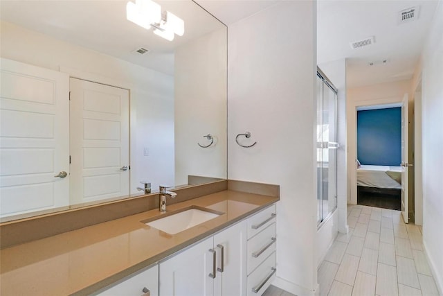 bathroom with vanity and a shower with shower door