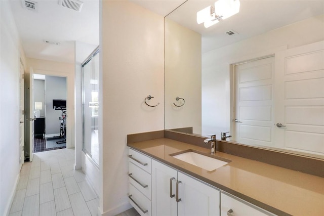 bathroom featuring vanity and an enclosed shower