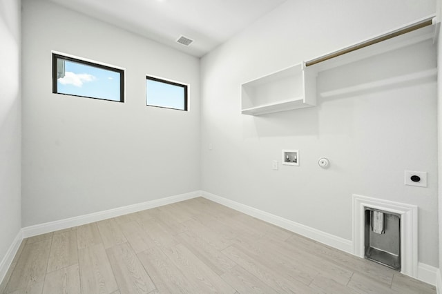 laundry room featuring washer hookup, light hardwood / wood-style flooring, hookup for a gas dryer, and electric dryer hookup