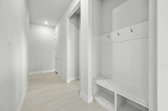 mudroom with light hardwood / wood-style floors