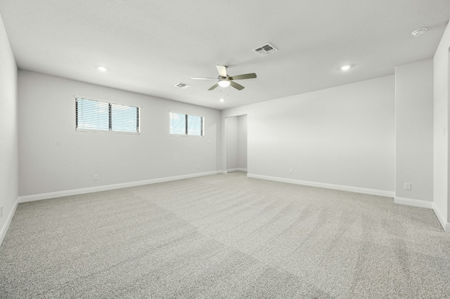 spare room with light carpet and ceiling fan