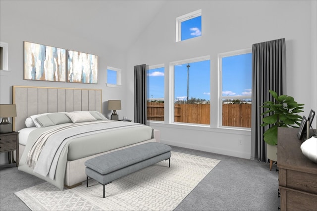 bedroom with carpet and high vaulted ceiling