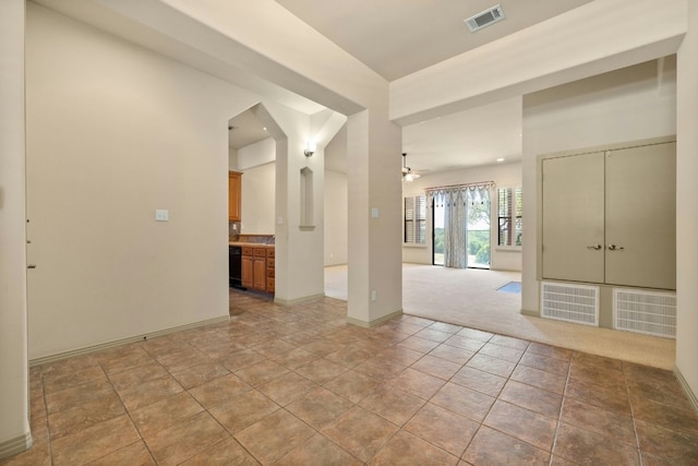 carpeted spare room with ceiling fan