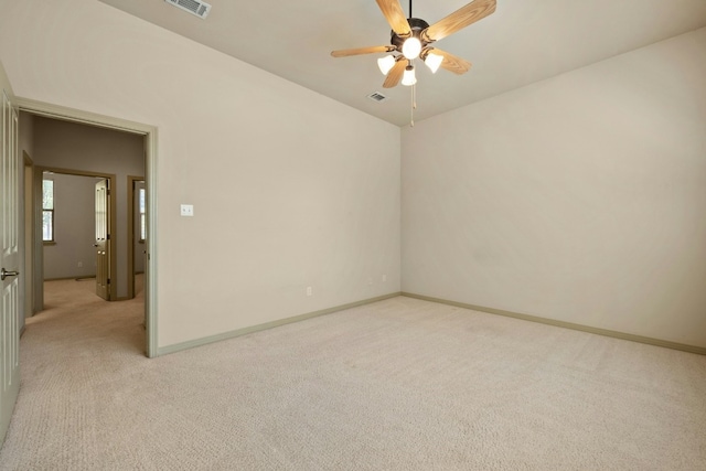 carpeted empty room featuring ceiling fan