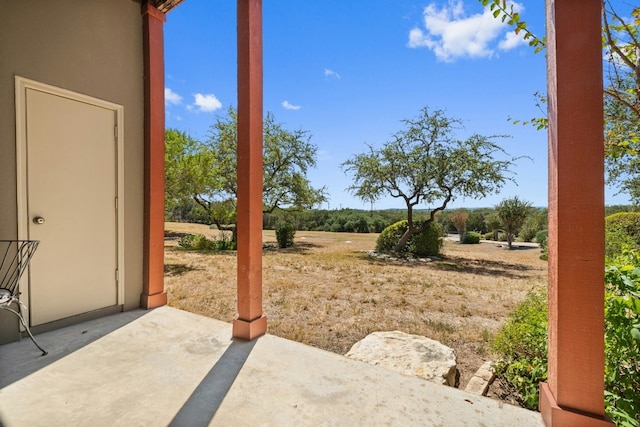 view of yard featuring a patio and a rural view