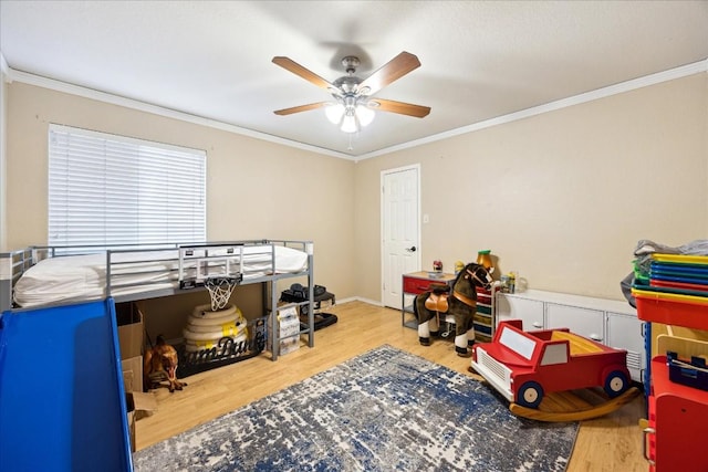 bedroom featuring ceiling fan, crown molding, and wood-type flooring