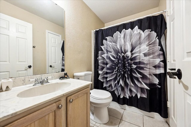 bathroom featuring vanity, tile patterned flooring, toilet, a textured ceiling, and walk in shower