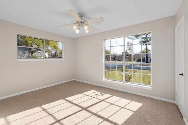 carpeted empty room featuring ceiling fan