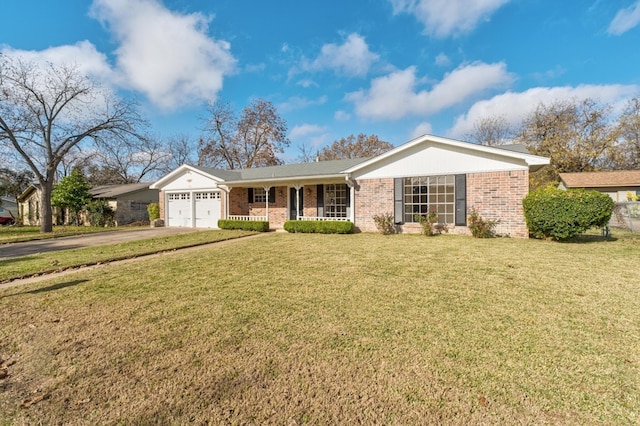 ranch-style house featuring covered porch, a garage, and a front yard