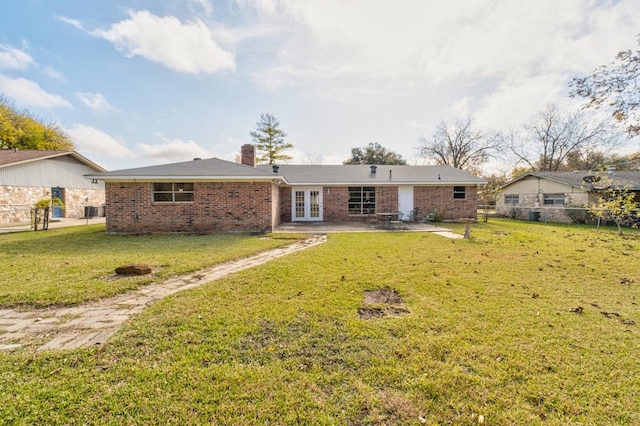 back of house with french doors, central AC, a patio area, and a lawn