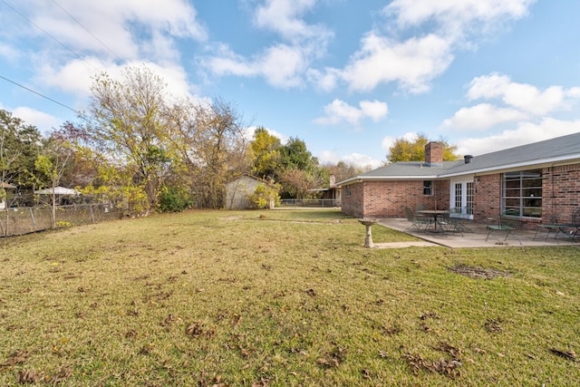 view of yard with a patio area and a storage shed