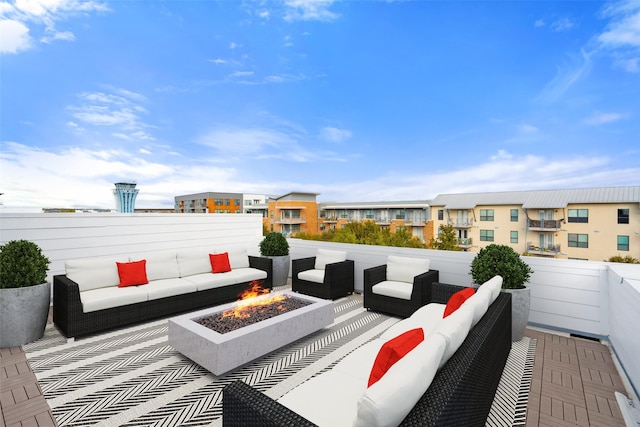 exterior space featuring an outdoor living space with a fire pit