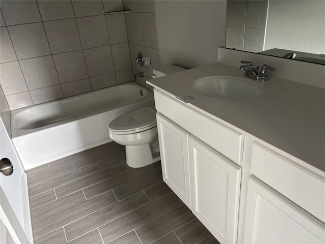 full bathroom featuring vanity, toilet, and tiled shower / bath