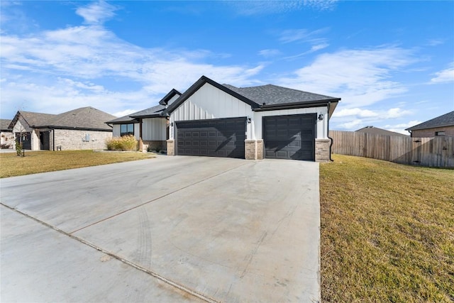 view of front of house with a garage and a front lawn