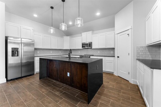 kitchen featuring pendant lighting, stainless steel appliances, white cabinetry, and sink