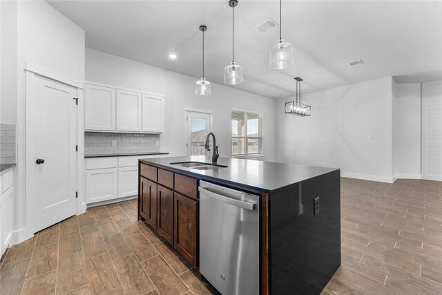 kitchen featuring dishwasher, sink, hanging light fixtures, an island with sink, and white cabinets