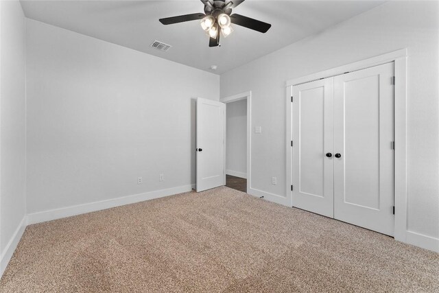 unfurnished bedroom with ceiling fan, a closet, and carpet floors