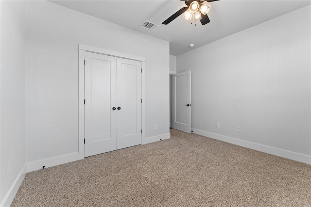 unfurnished bedroom with carpet, ceiling fan, and a closet