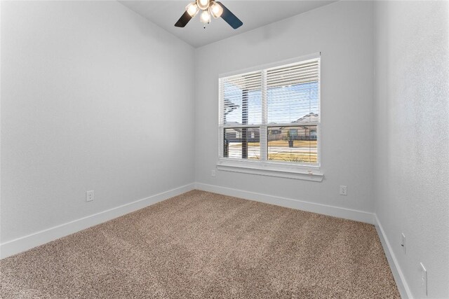 carpeted spare room featuring ceiling fan