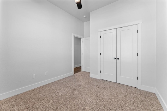 unfurnished bedroom featuring carpet, ceiling fan, and a closet