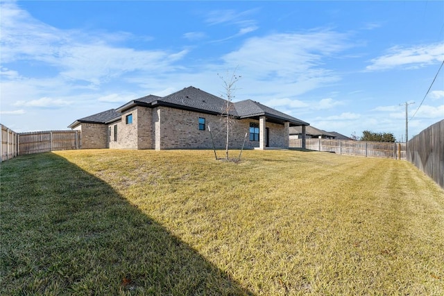 rear view of property with a lawn