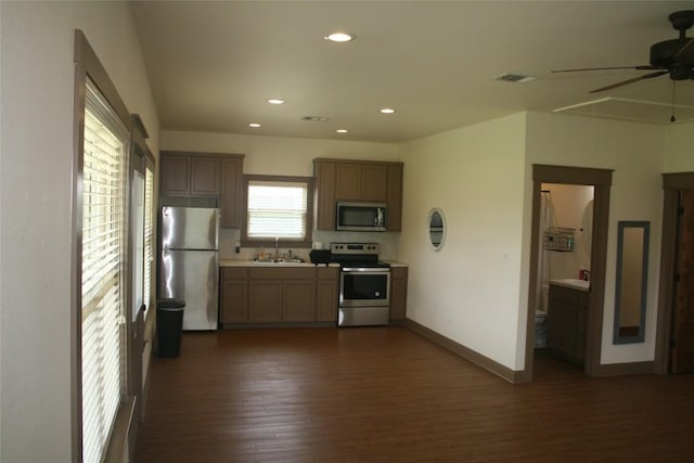 kitchen with dark hardwood / wood-style flooring, ceiling fan, sink, and appliances with stainless steel finishes