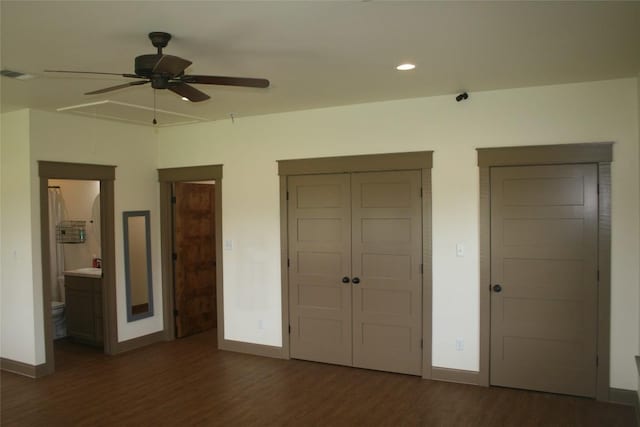 unfurnished bedroom with ceiling fan, dark hardwood / wood-style flooring, and connected bathroom