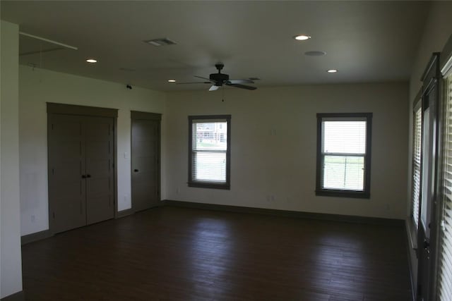 spare room with dark hardwood / wood-style floors and ceiling fan