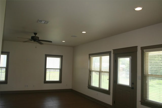 interior space with ceiling fan and dark wood-type flooring