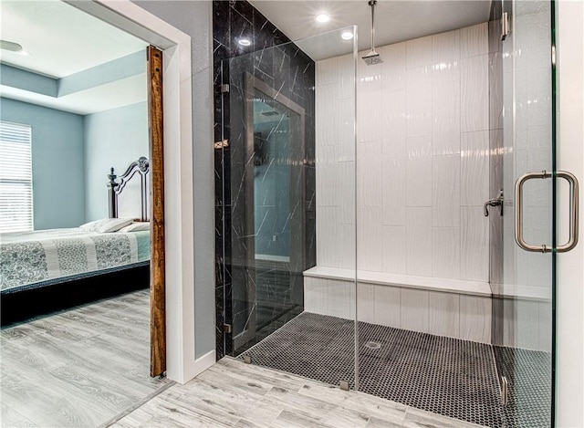 bathroom featuring an enclosed shower and hardwood / wood-style flooring