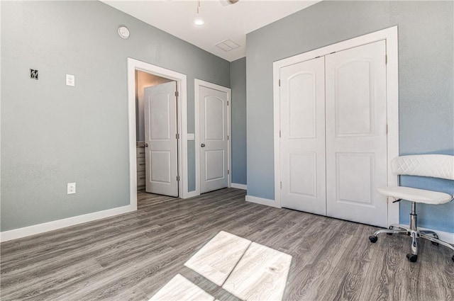 bedroom with light wood-type flooring and a closet